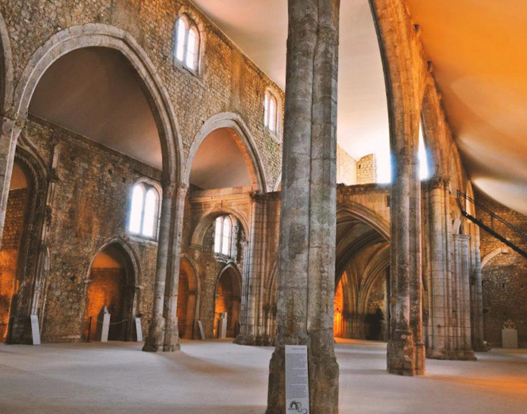 The interior of the Convent of St. Francis in Santarém; gothic arches raise to the ceiling, but it is otherwise empty.